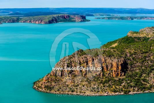 A sandstone headland in turquoise seas along the Kimberley Coast. Mitchell River National Park, Mitchell Plateau, Kimberley Coast, Western Australia, Australia.