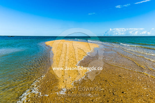 The rising tide swallows a small sand island. Montgomery Reef, Camden Sound, Kimberley Coast, Western Australia, Australia.