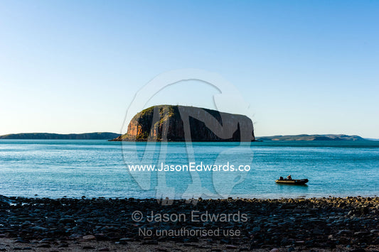A solitary dingy on the shore if an uninhabited beach at sunset. Raft Point, Doubtful Bay, Buccaneer Archipelago, Kimberley Coast, Western Australia, Australia.