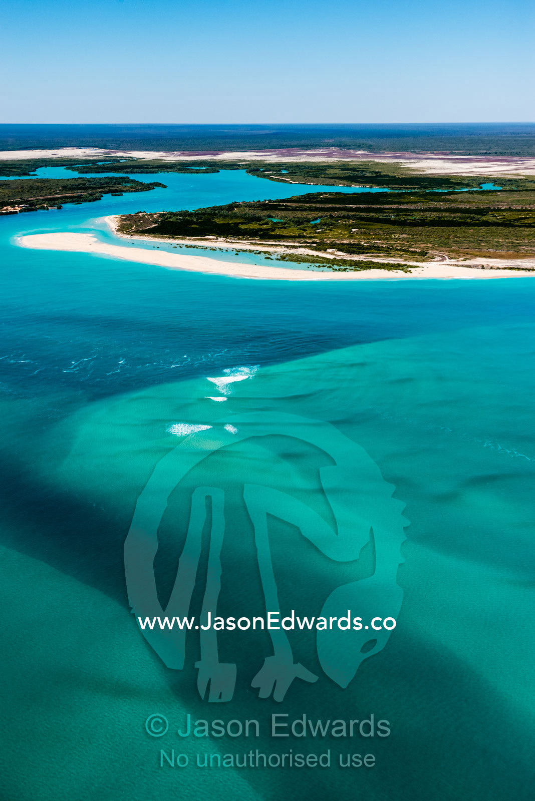 A tidal river inlet and white sandy beach in a pristine turquoise sea. Cable Beach, Willie Creek, Willie Creek Pearl Farm, Broome, Western Australia, Australia.