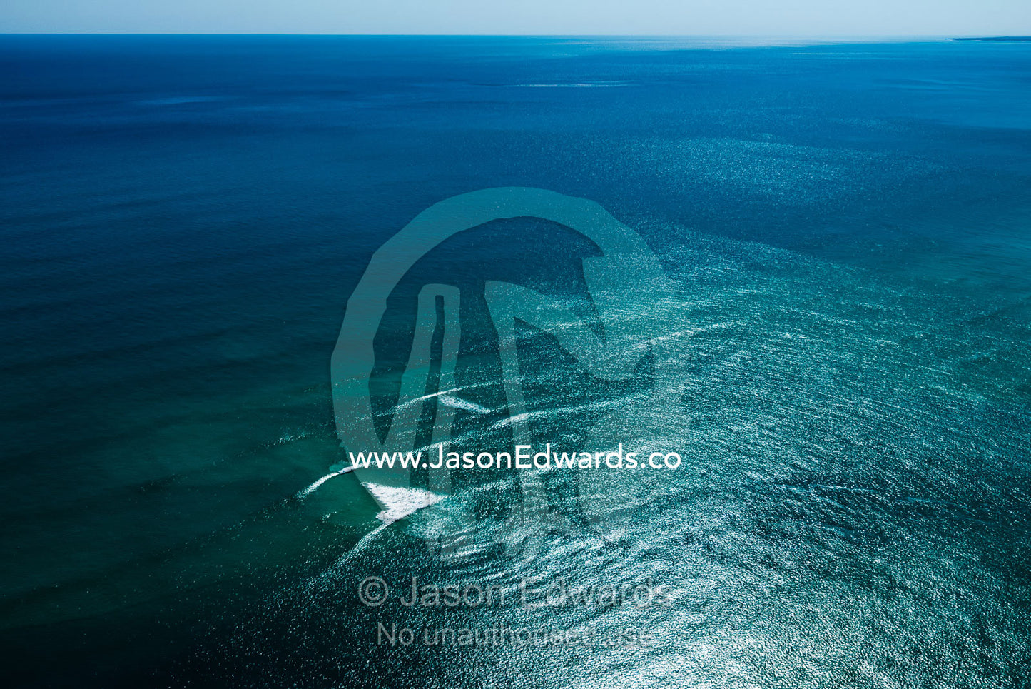 A wave breaks on a sand bar in the ocean. Cable Beach, Willie Creek Pearl Farm, Broome, Western Australia, Australia.