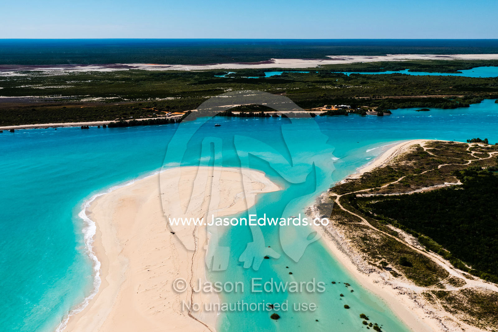 A tidal river inlet and white sandy beach in a pristine turquoise sea. Cable Beach, Willie Creek, Willie Creek Pearl Farm, Broome, Western Australia, Australia.