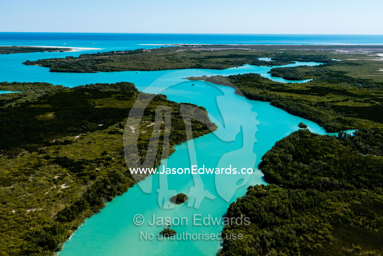 A turquoise tidal river winding it's way through mangroves in a tidal estuary. Willie Creek, Willie Creek Pearl Farm, Broome, Western Australia, Australia.