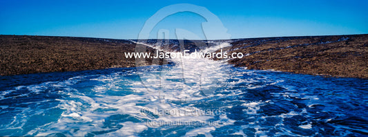 Water cascades from the surface of an exposed coral reef at low tide. Montgomery Reef, Camden Sound, Kimberley Coast, Western Australia, Australia.