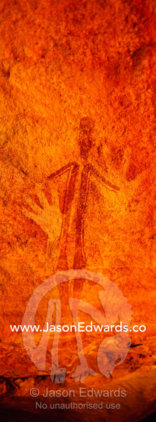 Ancient Aboriginal Gwion Gwion rock paintings also know as Bradshaw rock art featuring an hand stencils and a human figure estimated at 50,000 years old on a cave wall. Jar Island, Vansittart Bay, Kimberley Coast, Western Australia, Australia.