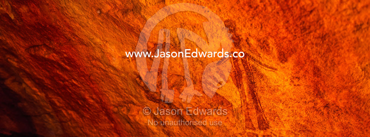 Ancient Aboriginal Gwion Gwion rock paintings also know as Bradshaw rock art featuring an hand stencils and a human figure estimated at 50,000 years old on a cave wall. Jar Island, Vansittart Bay, Kimberley Coast, Western Australia, Australia.