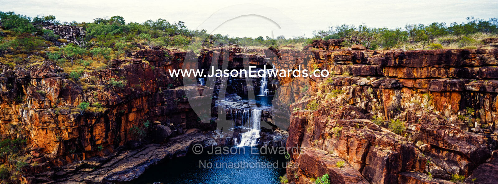 The magnificent Mitchell River cascades down ochre sandstone tiers in multiple waterfalls. Mitchell Falls, Mitchell River National Park, Mitchell Plateau, Kimberley Coast, Western Australia, Australia.