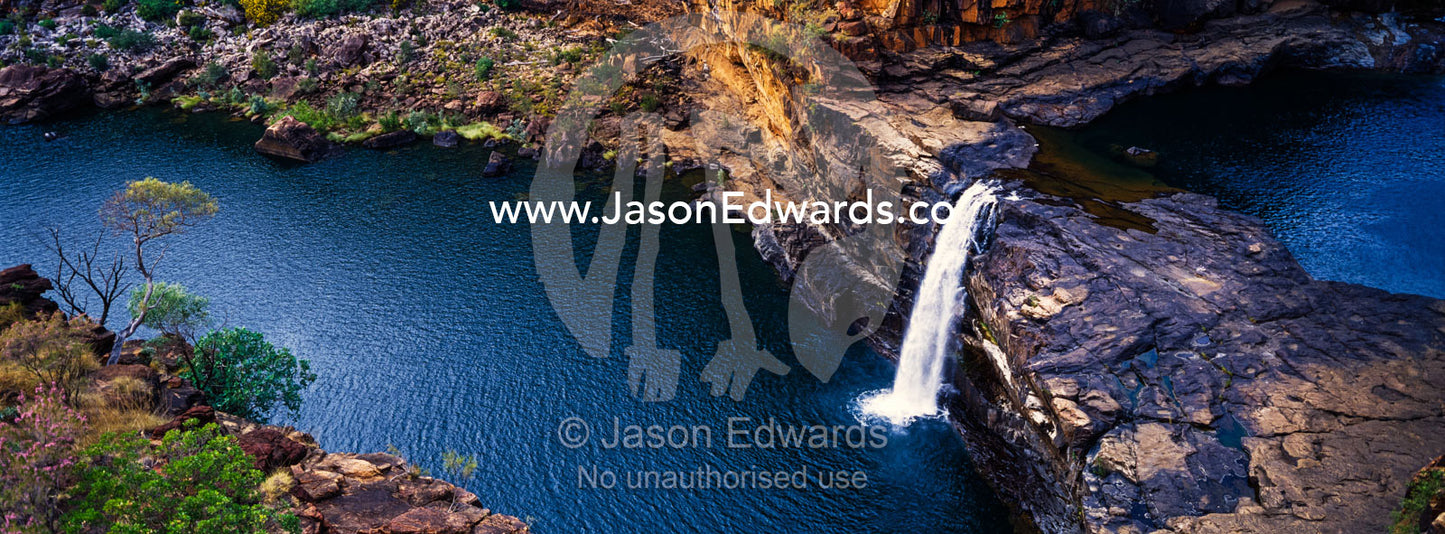 The magnificent Mitchell River cascades down ochre sandstone tiers in multiple waterfalls. Mitchell Falls, Mitchell River National Park, Mitchell Plateau, Kimberley Coast, Western Australia, Australia.