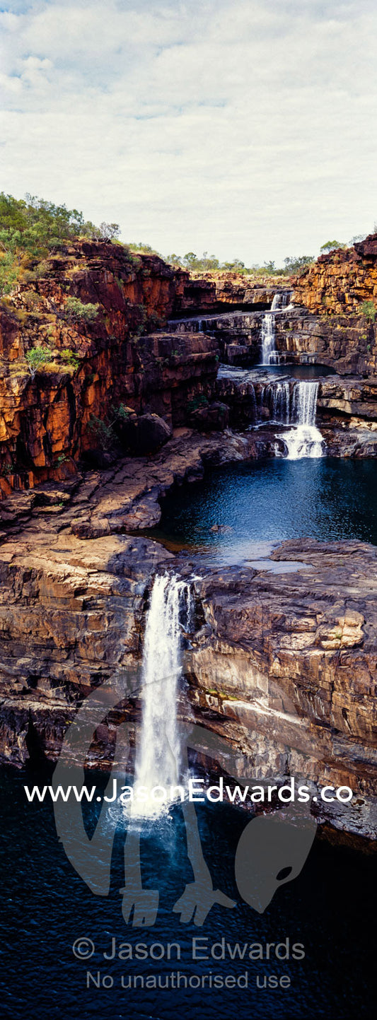 The magnificent Mitchell River cascades down ochre sandstone tiers in multiple waterfalls. Mitchell Falls, Mitchell River National Park, Mitchell Plateau, Kimberley Coast, Western Australia, Australia.