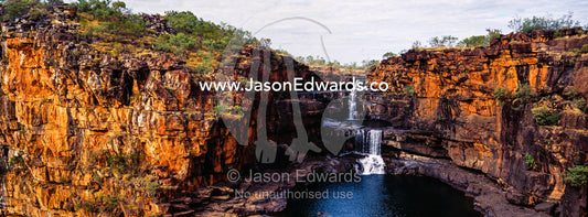 The magnificent Mitchell River cascades down ochre sandstone tiers in multiple waterfalls. Mitchell Falls, Mitchell River National Park, Mitchell Plateau, Kimberley Coast, Western Australia, Australia.