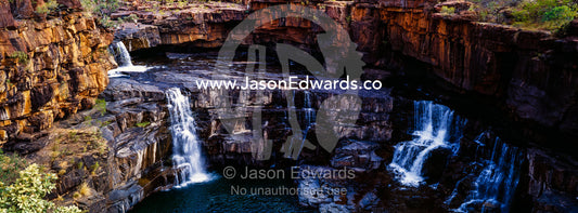 The magnificent Mitchell River cascades down ochre sandstone tiers in multiple waterfalls. Mitchell Falls, Mitchell River National Park, Mitchell Plateau, Kimberley Coast, Western Australia, Australia.