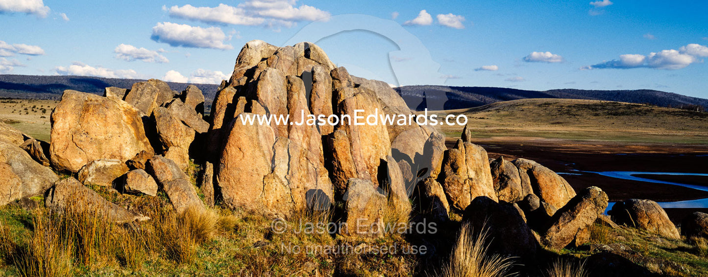 A cluster of jagged granite boulders overlooking an alpine river plain at sunset. The Domestics near Currango Homestead, Kosciuszko National Park, New South Wales, Australia.