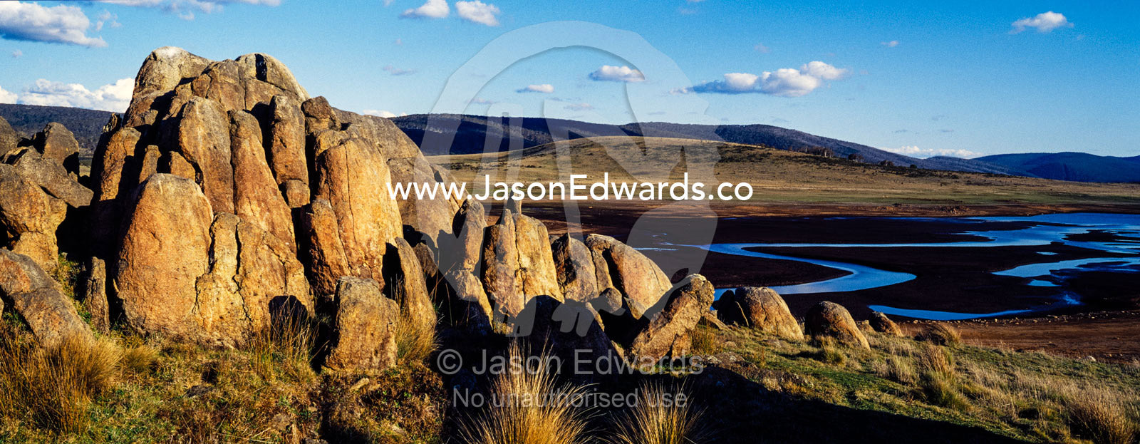 A cluster of jagged granite boulders overlooking an alpine river plain at sunset. The Domestics near Currango Homestead, Kosciuszko National Park, New South Wales, Australia.