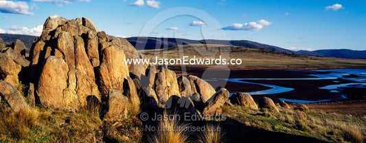 A cluster of jagged granite boulders overlooking an alpine river plain at sunset. The Domestics near Currango Homestead, Kosciuszko National Park, New South Wales, Australia.