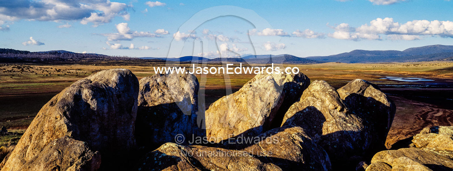 A cluster of jagged granite boulders overlooking an alpine river plain at sunset. The Domestics near Currango Homestead, Kosciuszko National Park, New South Wales, Australia.