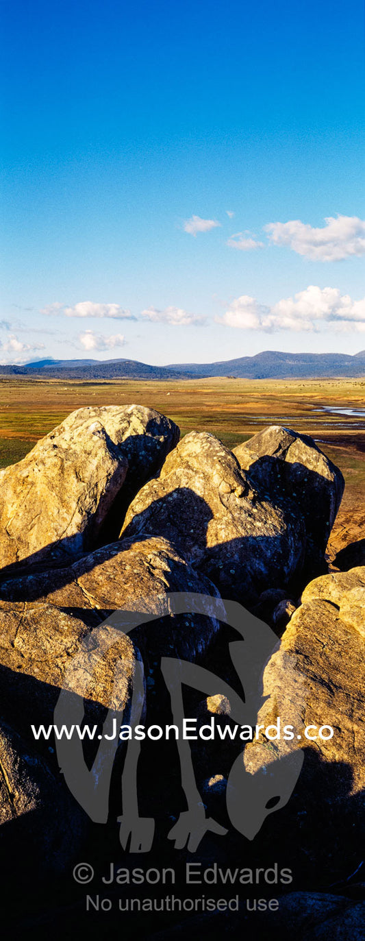 A cluster of jagged granite boulders overlooking an alpine river plain at sunset. The Domestics near Currango Homestead, Kosciuszko National Park, New South Wales, Australia.