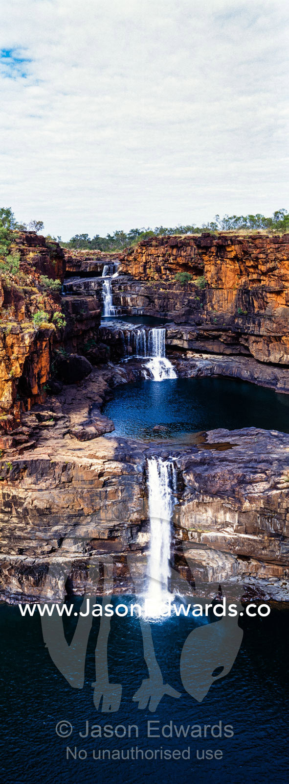 The magnificent Mitchell River cascades down ochre sandstone tiers in multiple waterfalls. Mitchell Falls, Mitchell River National Park, Mitchell Plateau, Kimberley Coast, Western Australia, Australia.
