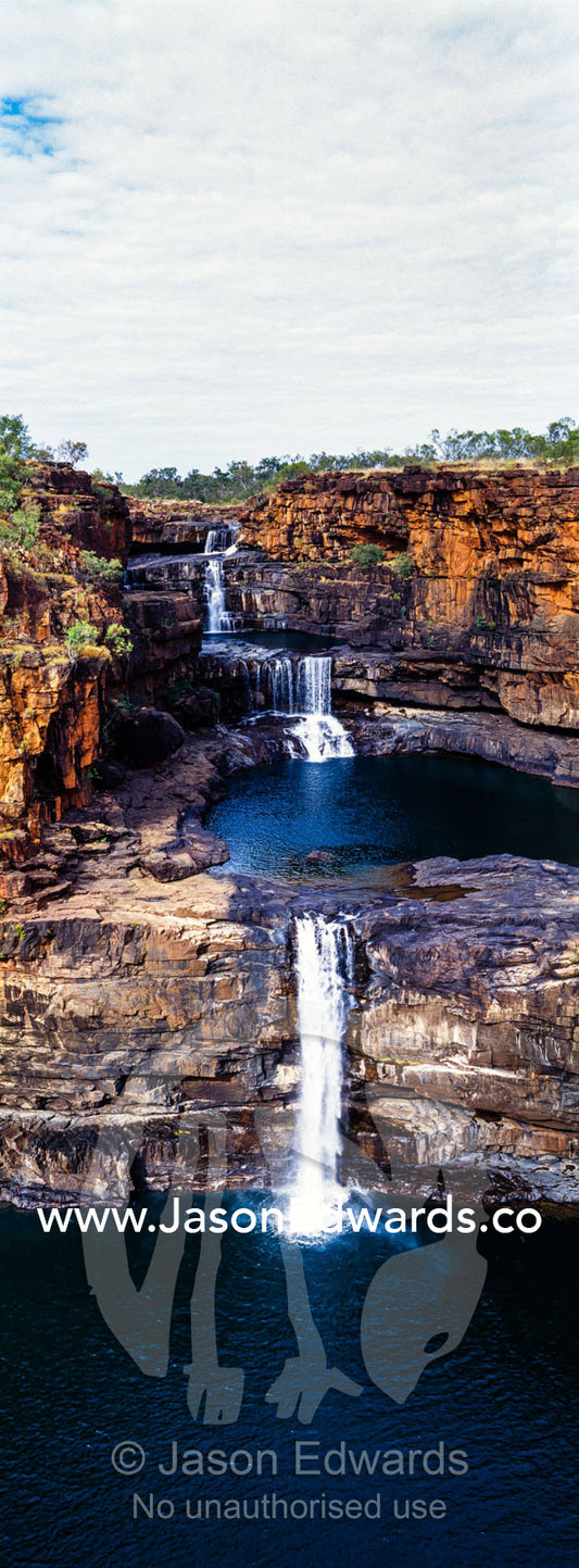 The magnificent Mitchell River cascades down ochre sandstone tiers in multiple waterfalls. Mitchell Falls, Mitchell River National Park, Mitchell Plateau, Kimberley Coast, Western Australia, Australia.