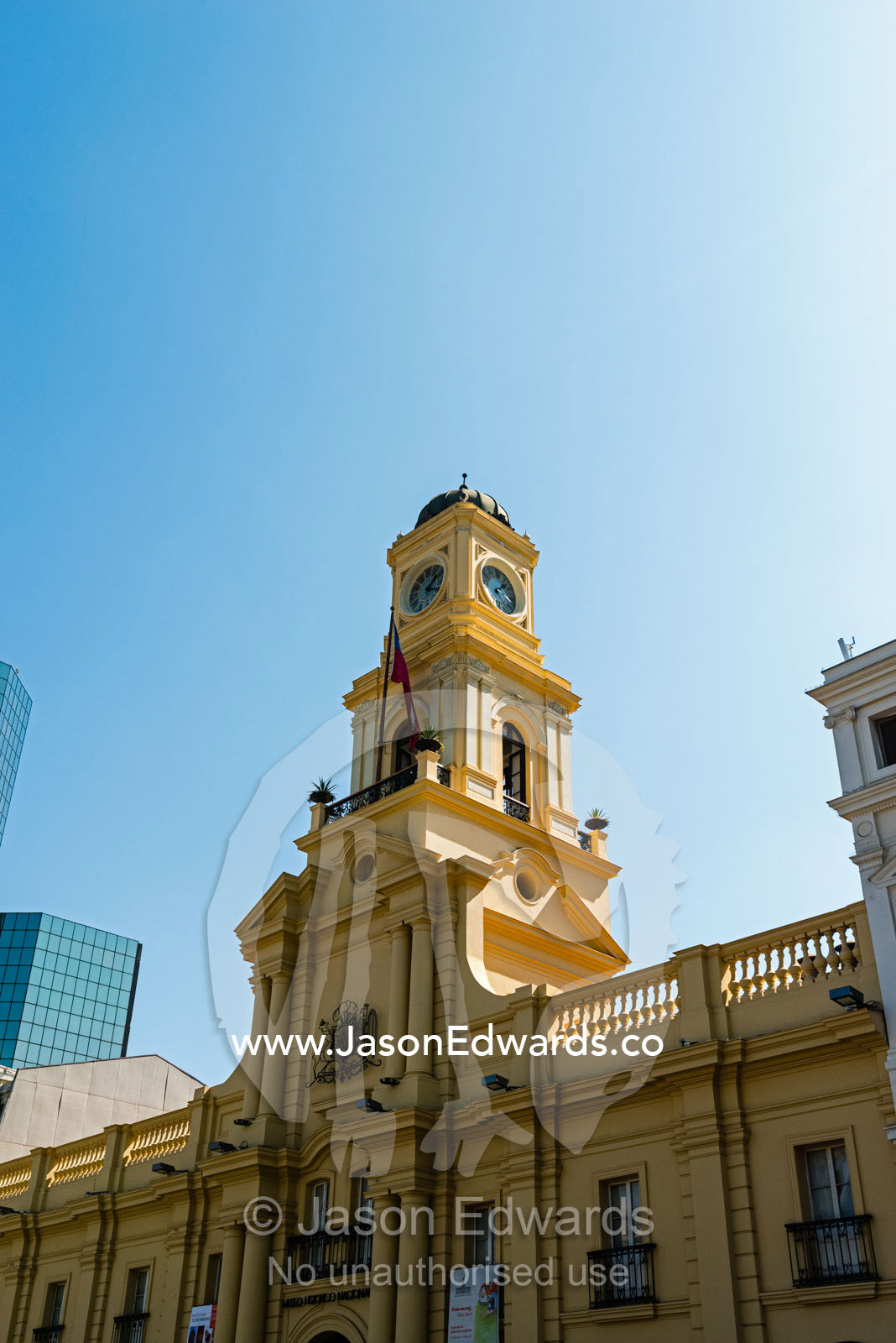 The facade and clock tower of a heritage Museum overlooking the Plaza de Armas. Santiago, Chile.