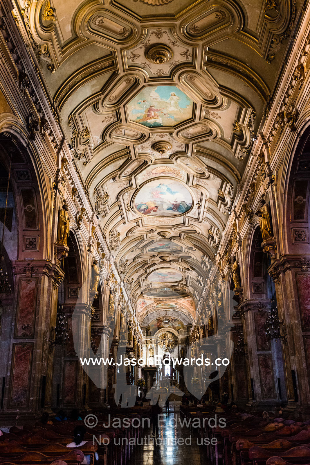 The ornate ceiling, pillars and nave of a catholic church. Santiago, Chile.