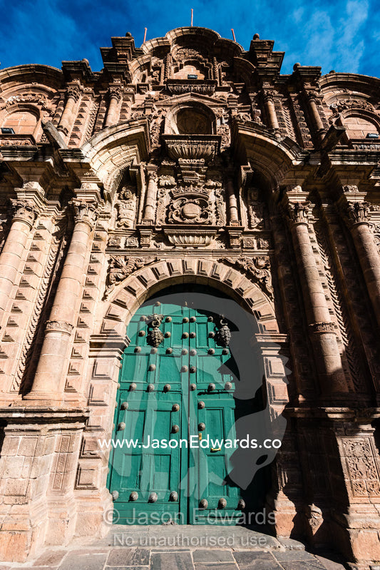 A steel studded door in the ornate facade of the Jesuit Church of the Society of Jesus. Cusco, Peru.