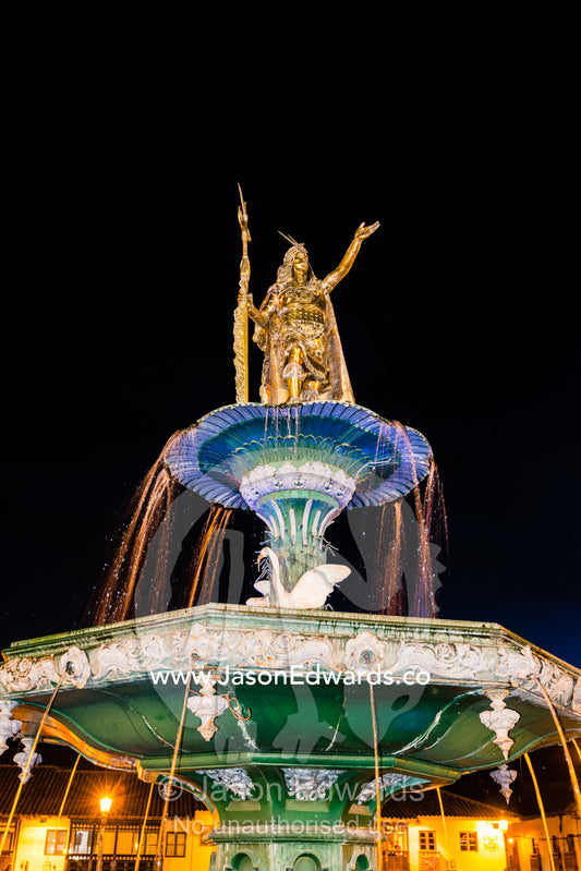 The Inca Pachacutec Fountain illuminated at night in the Plaza de Armas. Cusco, Peru.