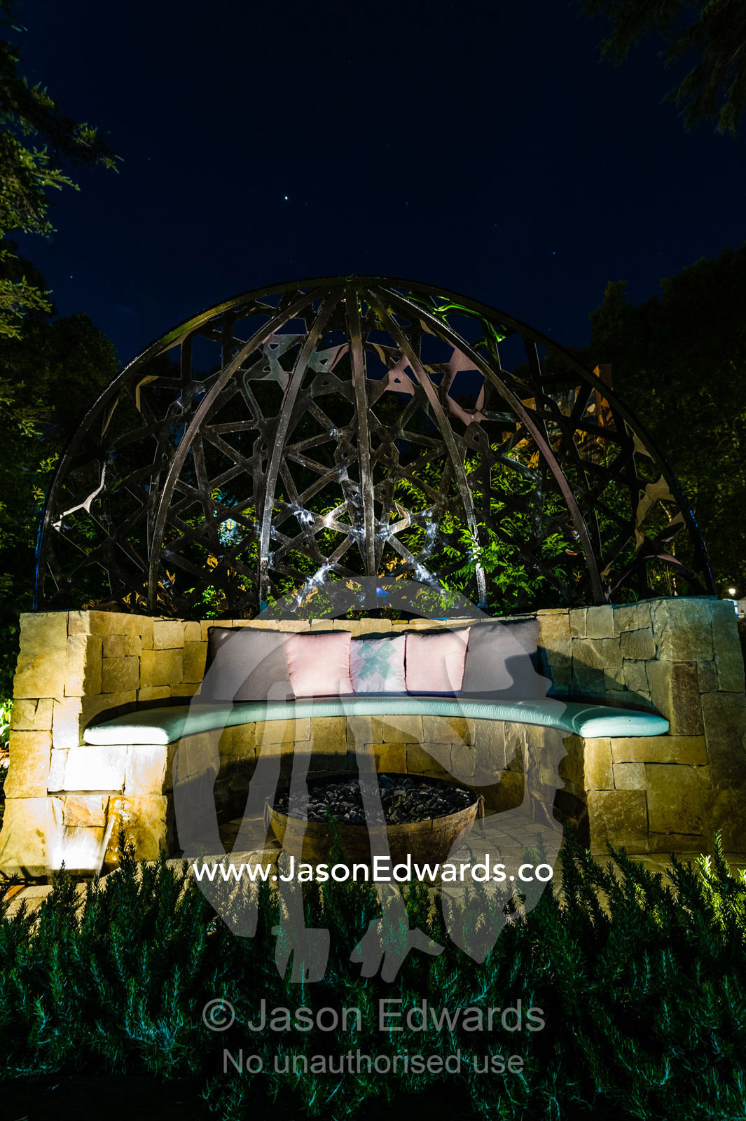 A handmade stone garden seat and fire pit in a city park. Melbourne, Victoria, Australia.
