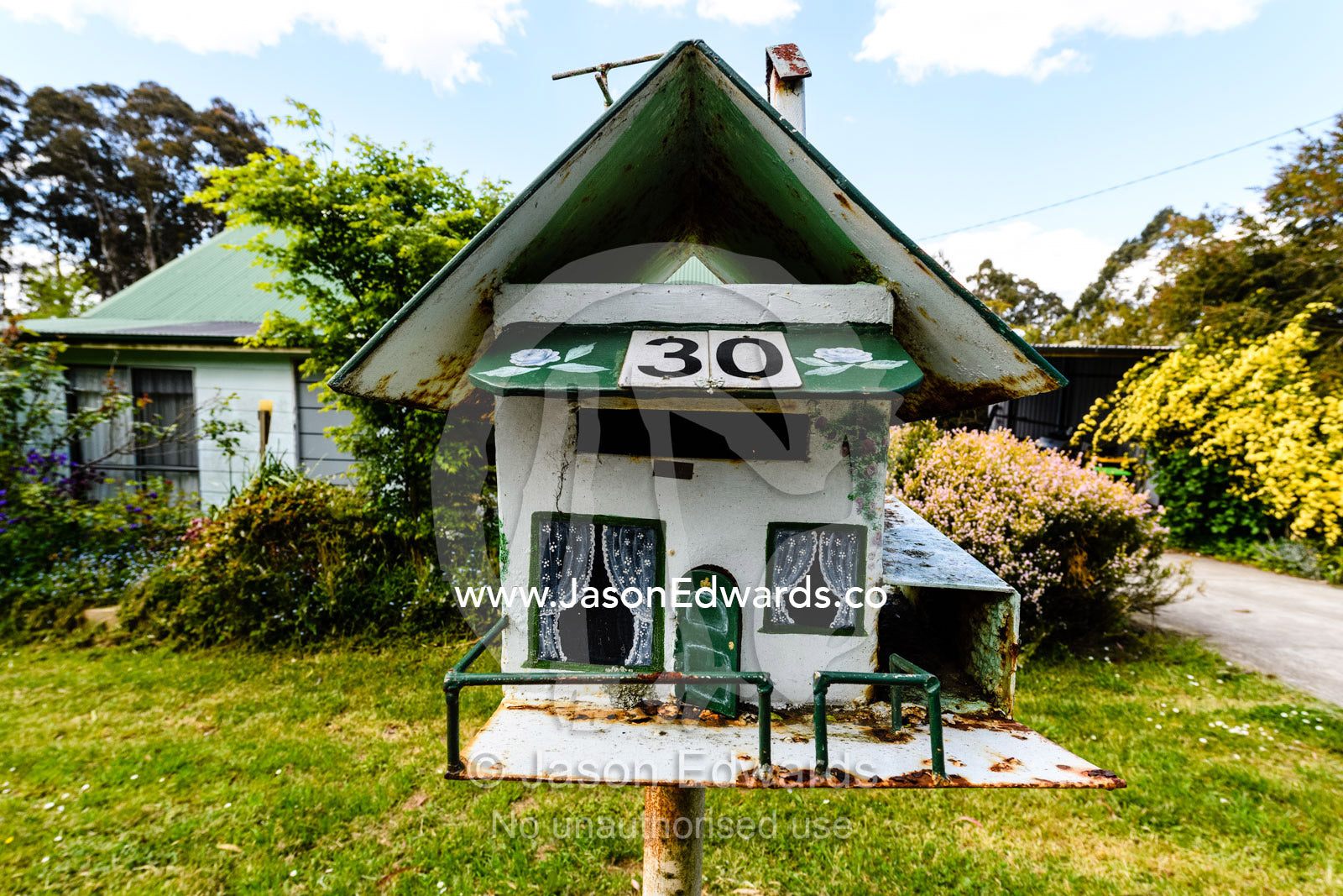 A mailbox made to look like a small house in a country town. Carrajung, Victoria, Australia.
