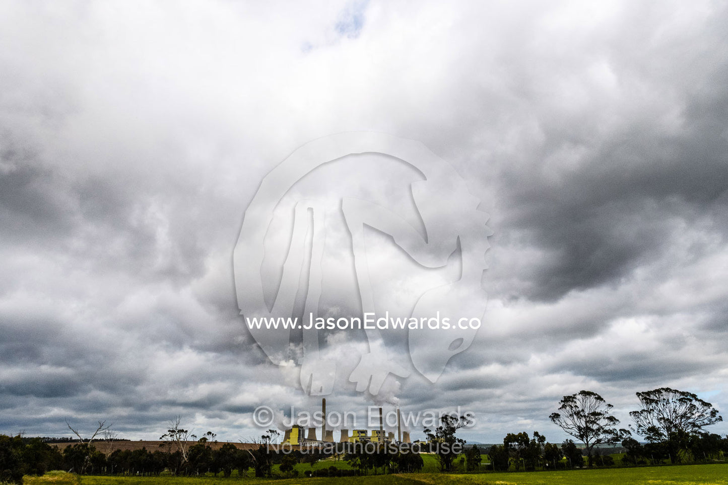 Steam and pollution pour from chimneys at a coal powered electricity station. Traralgon, Victoria, Australia.