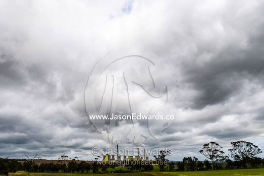 Steam and pollution pour from chimneys at a coal powered electricity station. Traralgon, Victoria, Australia.