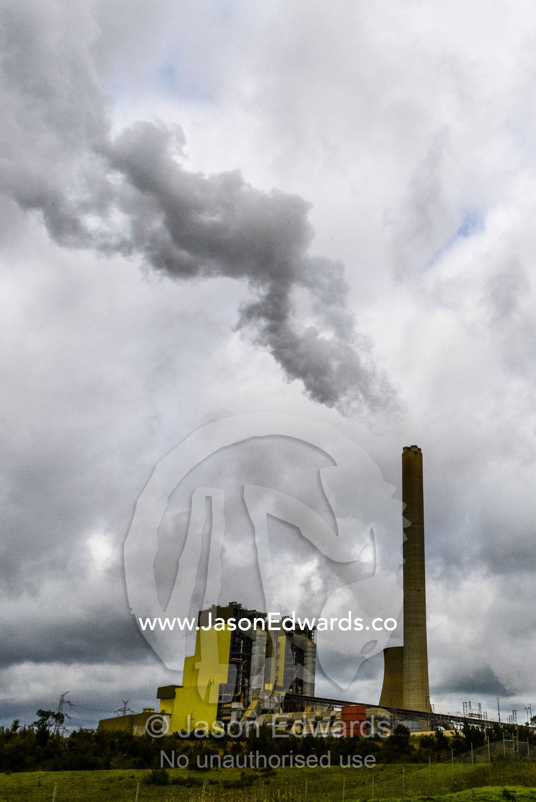 Steam and pollution pour from chimneys at a coal powered electricity station. Traralgon, Victoria, Australia.