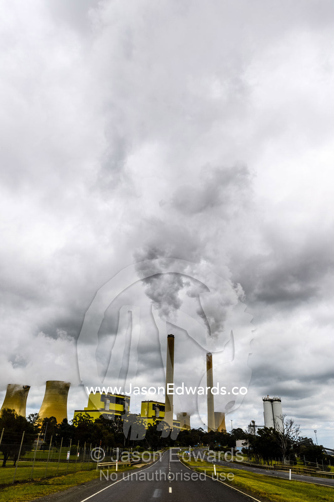 Steam and pollution pour from chimneys at a coal powered electricity station. Traralgon, Victoria, Australia.