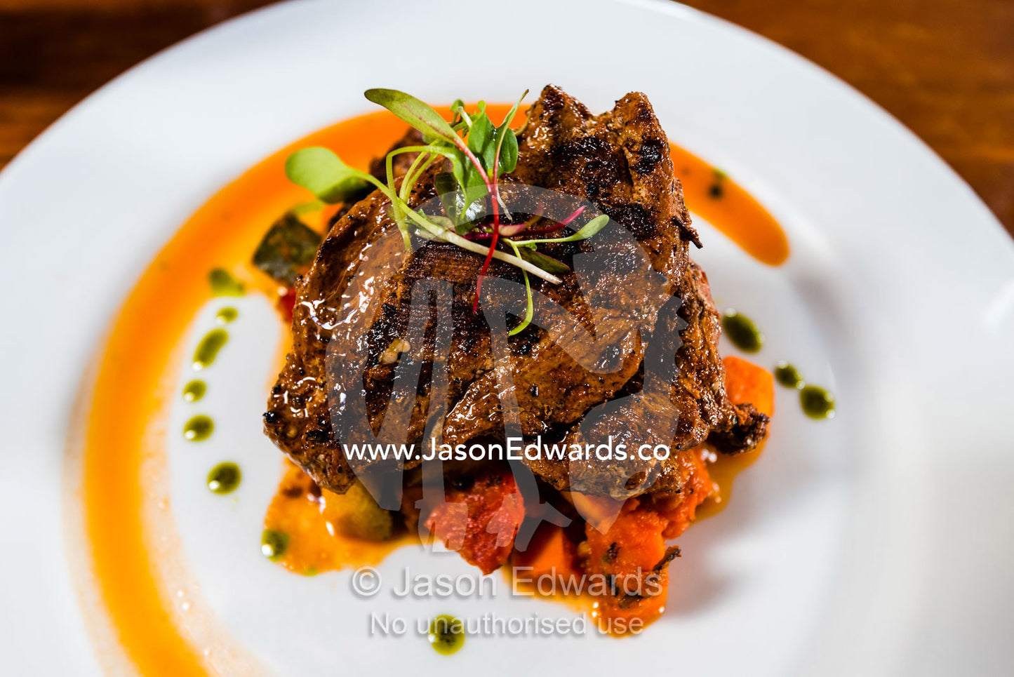 A gourmet chef prepared meal of roasted alpaca and peppers. Cusco, Peru.