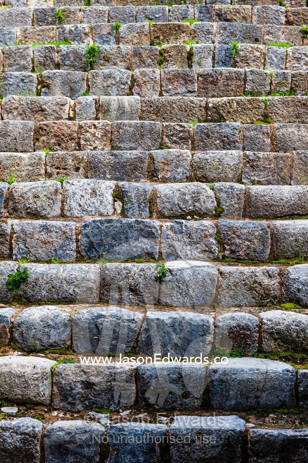 A flight of steps carved from granite boulders in an Inca citadel. Cusco, Peru.