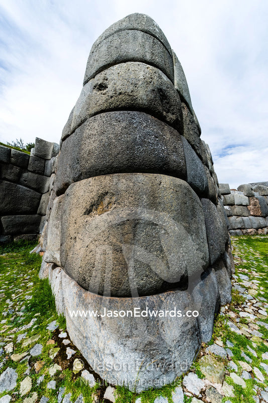The Inca carved interlocking dry-stone walls from boulders to build a citadel terrace wall. Cusco, Peru.