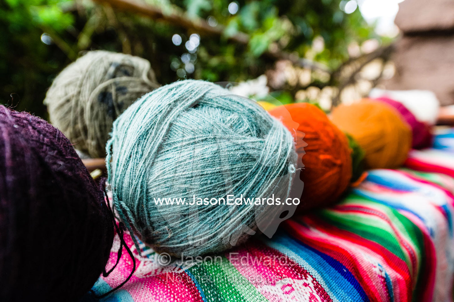 Amaru people using natural dyes to colour sheeps wool to make balls of yarn. Pisac, Peru.