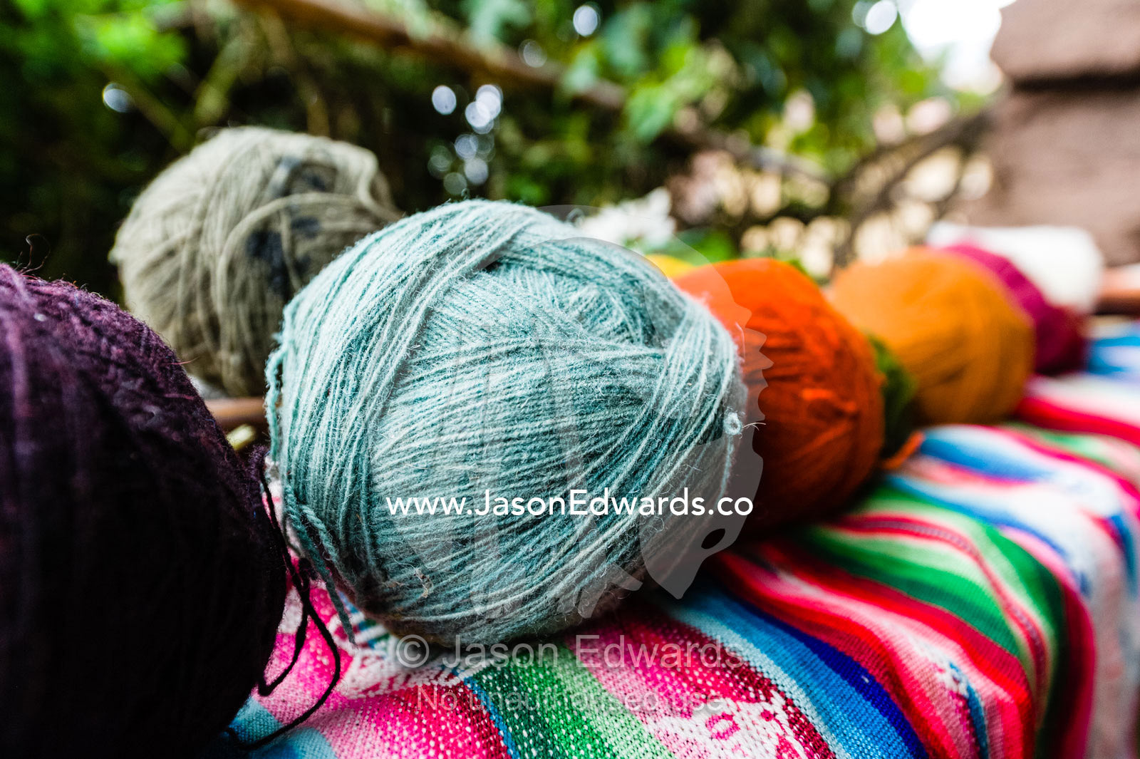 Amaru people using natural dyes to colour sheeps wool to make balls of yarn. Pisac, Peru.
