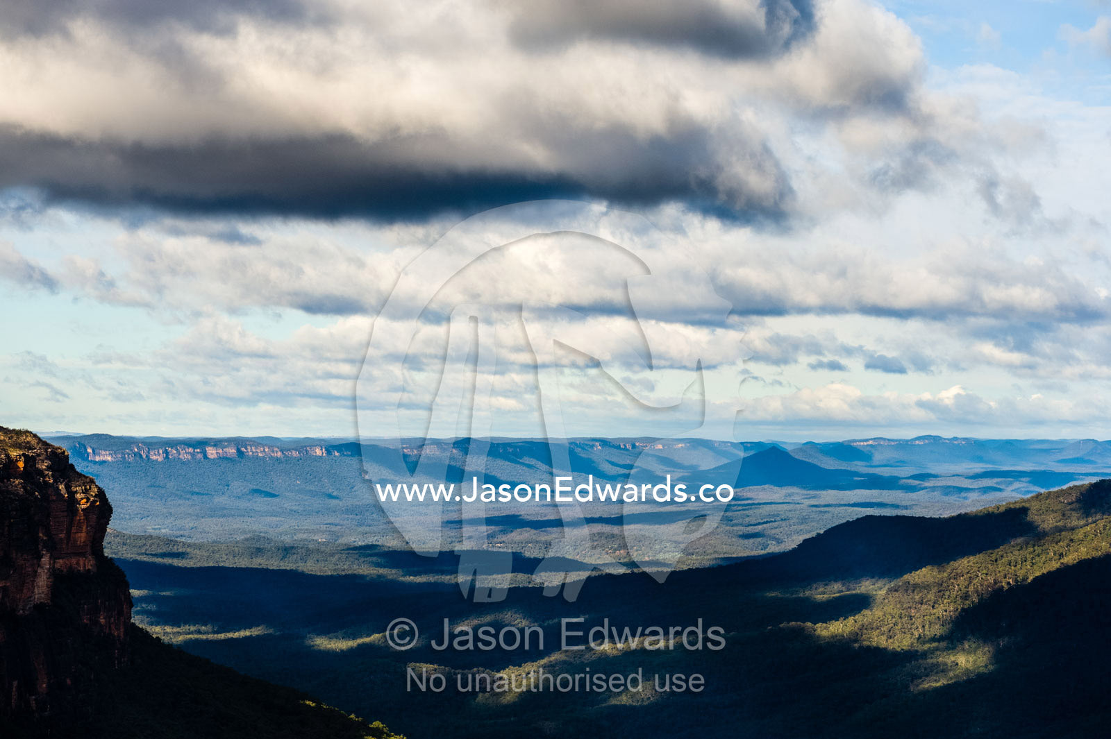 Storm clouds roll over a valley shrouded in dense forest. Blue Mountains National Park, New South Wales, Australia.