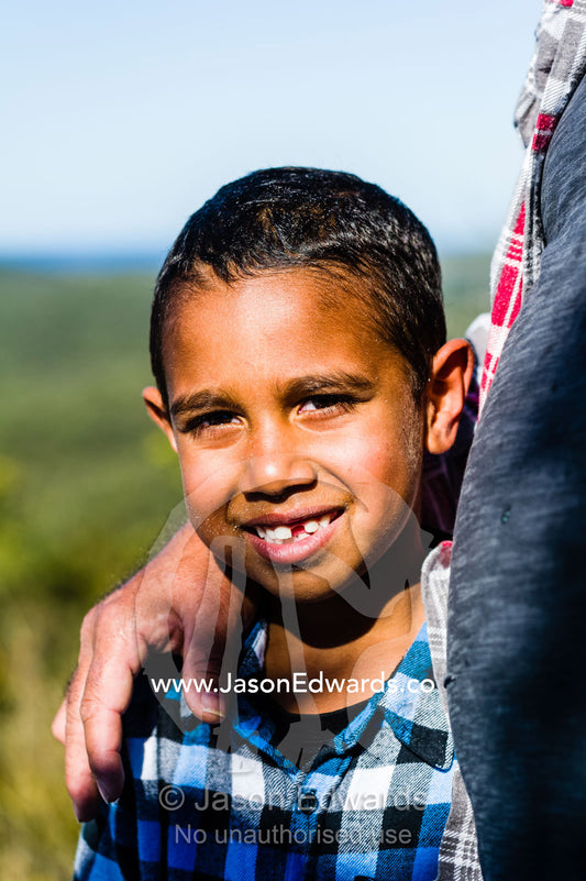 An Aboriginal boy cradled in his father's arms. Blue Lake National Park, Queensland, Australia.