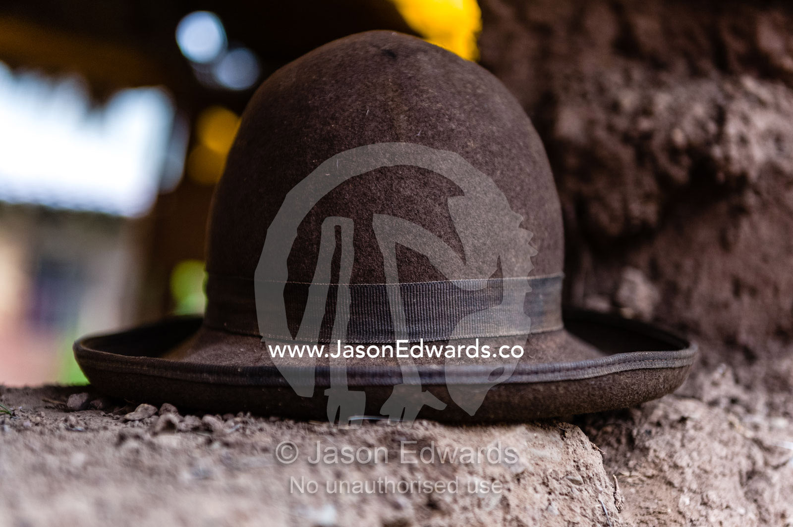 A felt Montera hat on a mud brick wall. Pisac, Peru.