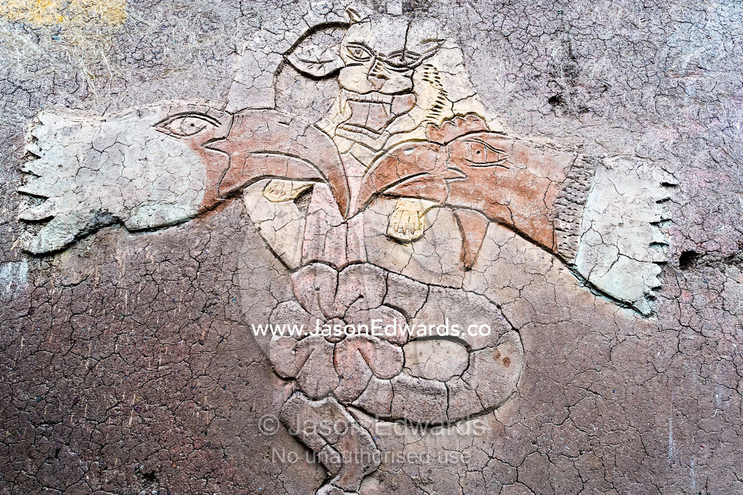 An artistic representation of a Puma god on the wall of a mud brick house in the Andes. Pisac, Peru.