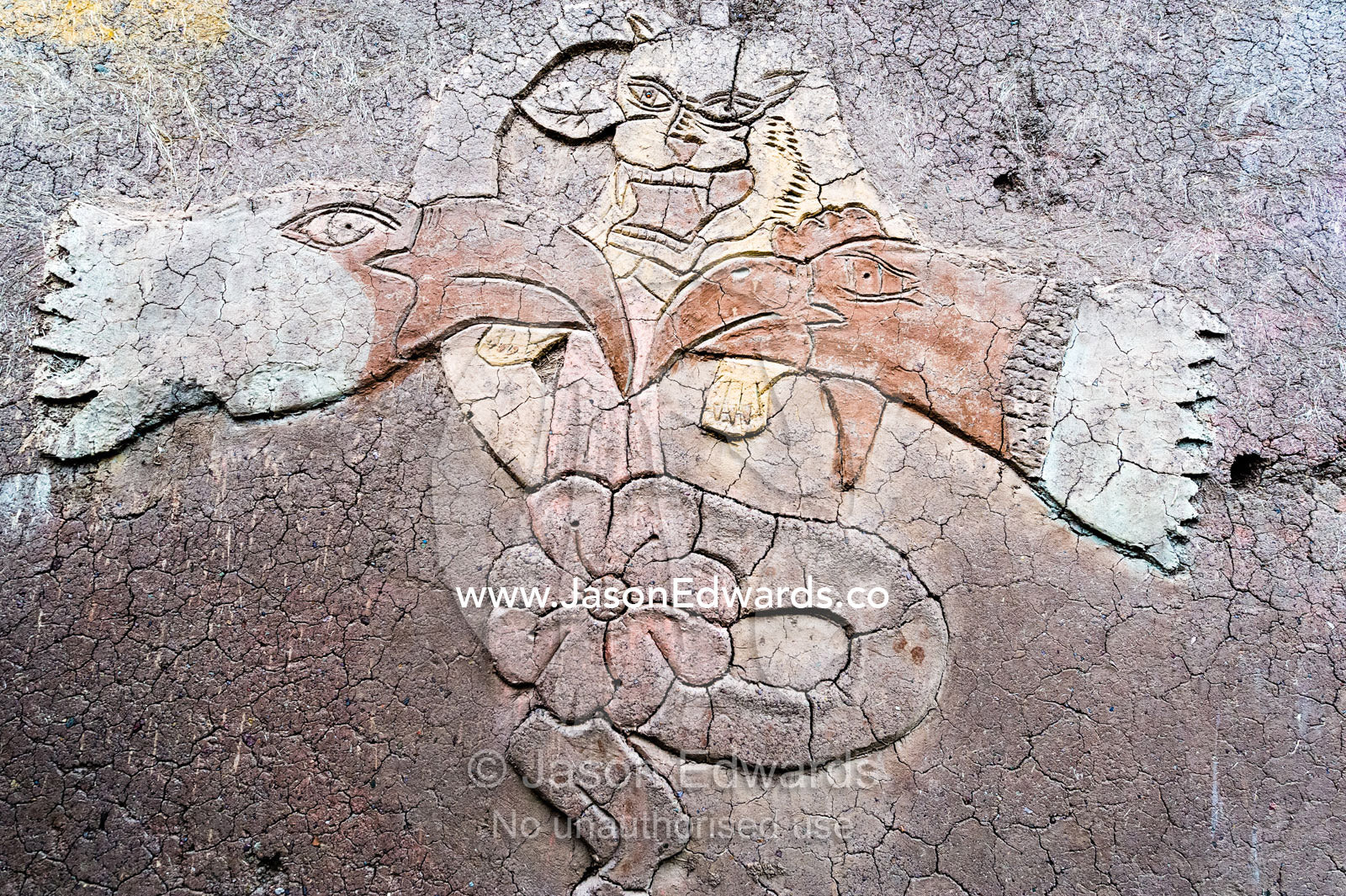 An artistic representation of a Puma god on the wall of a mud brick house in the Andes. Pisac, Peru.