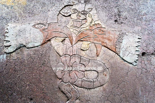 An artistic representation of a Puma god on the wall of a mud brick house in the Andes. Pisac, Peru.