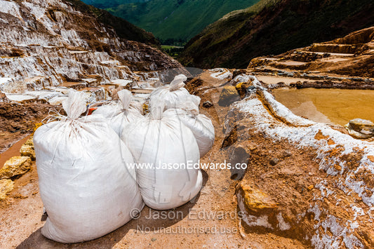 Bags of clay at an Inca salt mine. Maras, Peru.