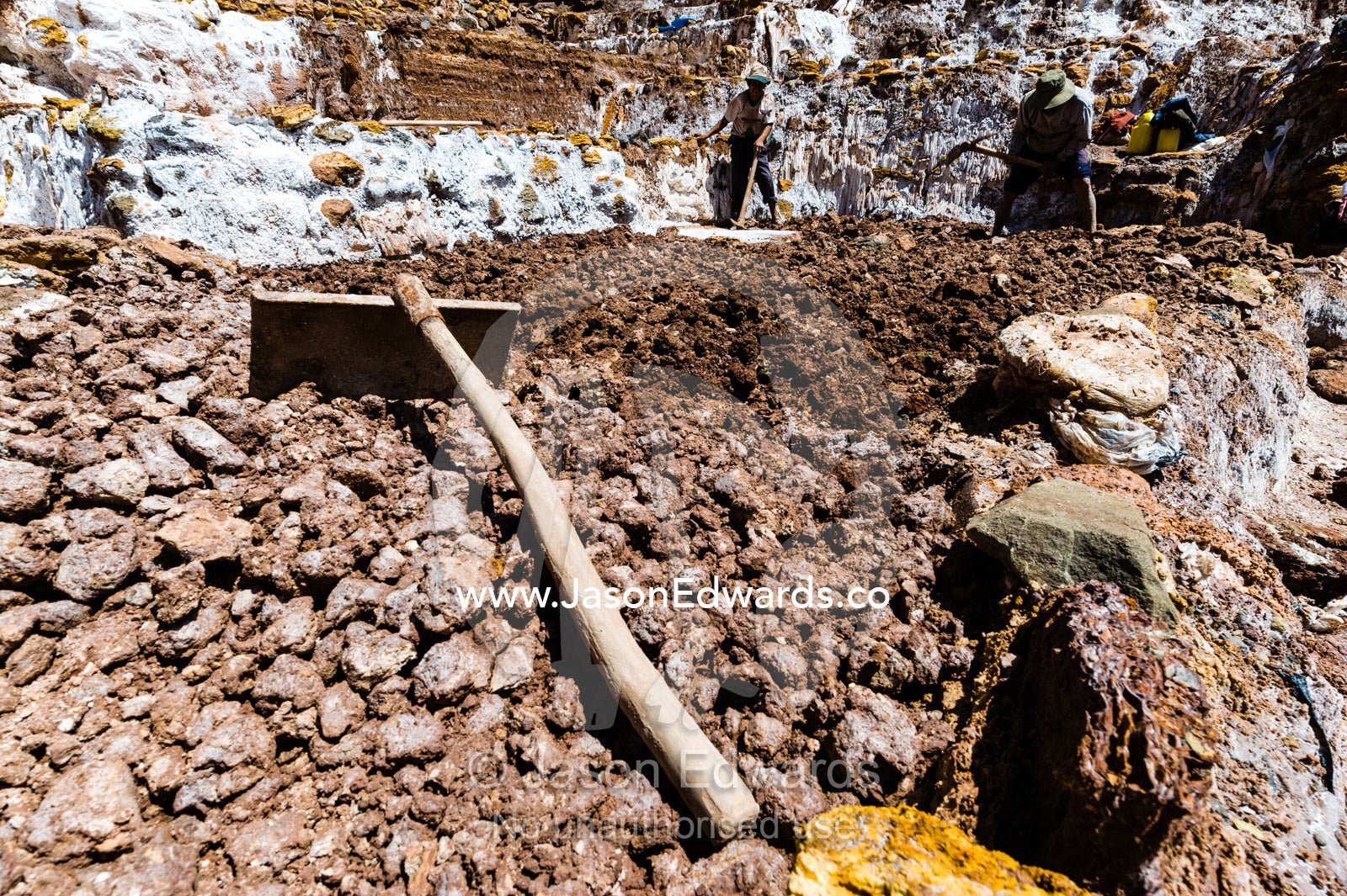 A spade lying on rocks at a salt mine. Maras, Peru.
