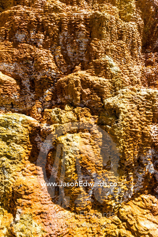 The clay terrace wall of an ancient Inca salt mine. Maras, Peru.