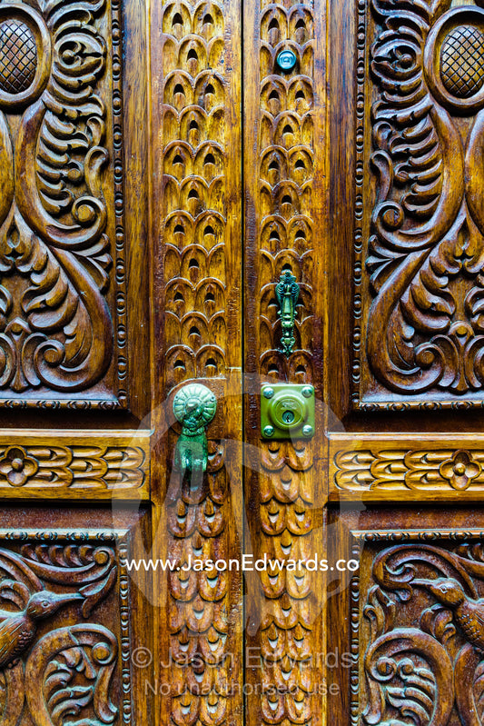 An intricately carved wooden door. Ollantaytambo, Peru.