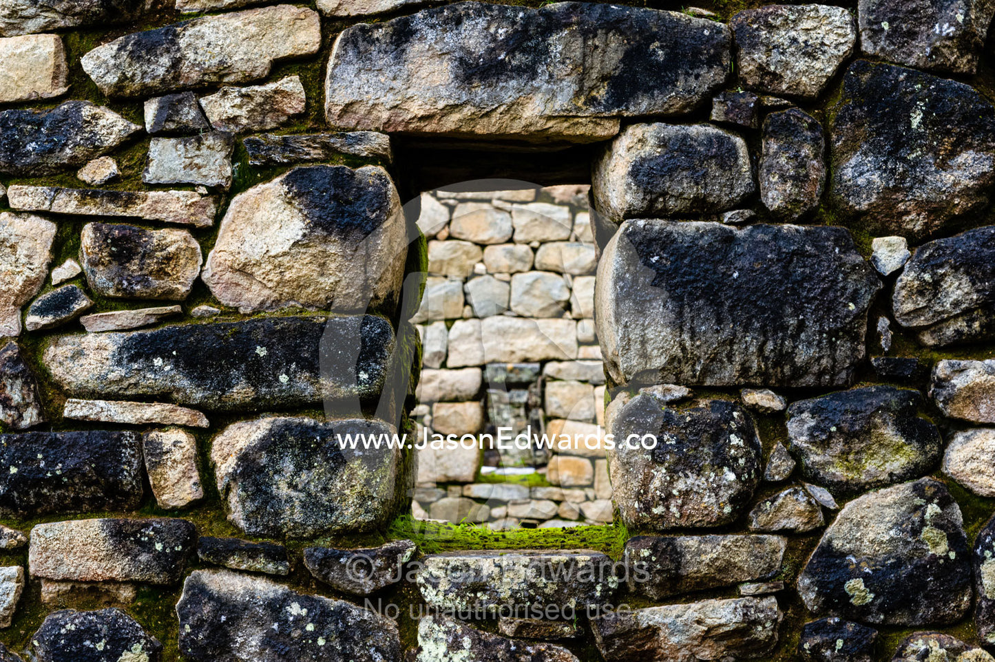 A window in a trapezoidal wall in a residential building at Macchu Picchu. Peru.