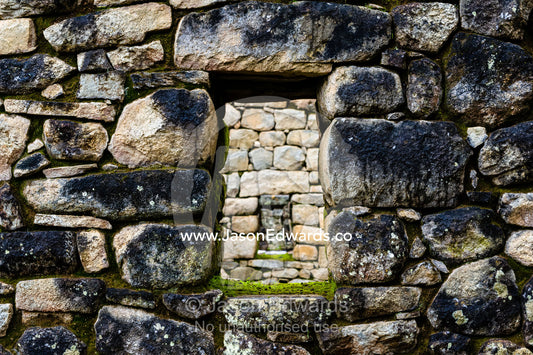 A window in a trapezoidal wall in a residential building at Macchu Picchu. Peru.