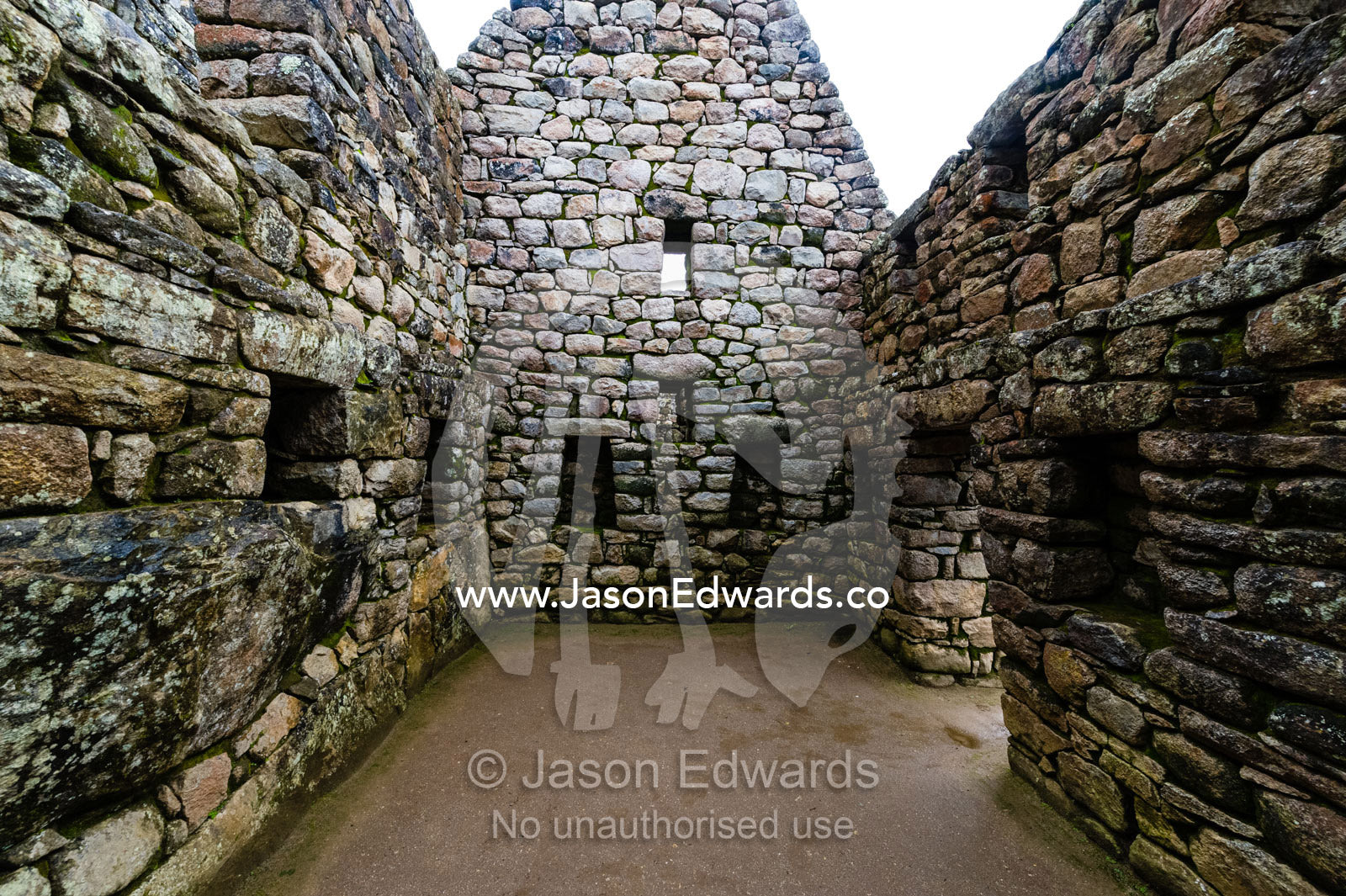 A window in a trapezoidal wall in a residential building at Macchu Picchu. Peru.